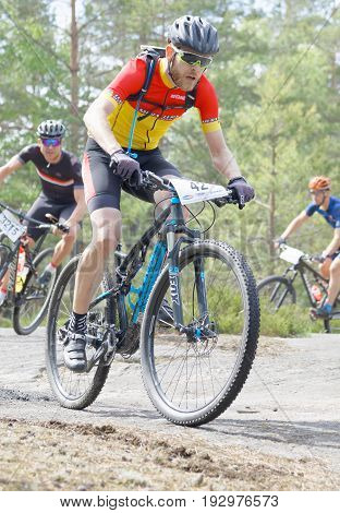 STOCKHOLM SWEDEN - JUNE 11 2017: Closeup of group of mountain bike cyclists in the forest at Lida Loop Mountain bike Race. June 11 2017 in Stockholm Sweden