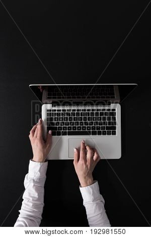 Cropped Shot Of Woman Working On Laptop Isolated On Black