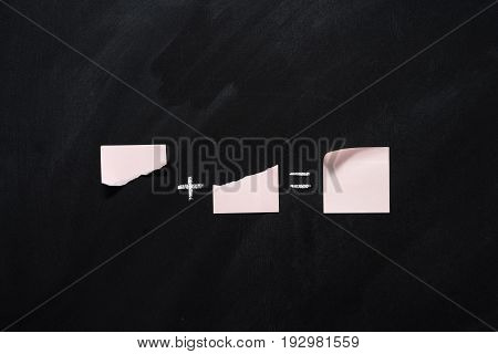 mathematical example made of blank notes on black chalkboard