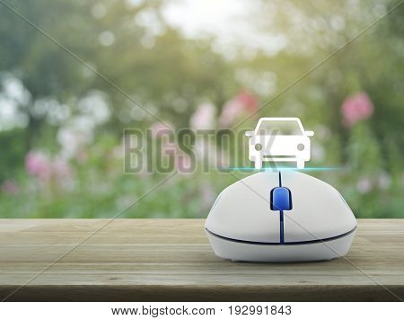 Car flat icon with wireless computer mouse over blur pink flower and tree Internet transportation service concept