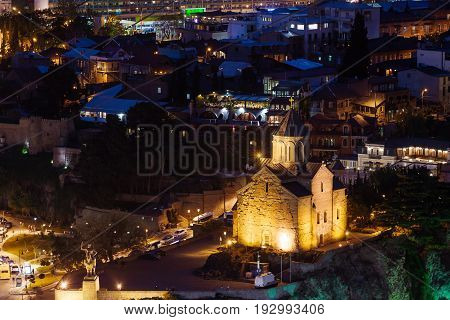 Night aerial view on Metekhi Church of the Dormition of the virgin.Monument to Vakhtang I Gorgasali. Famous landmarks in Tbilisi Georgia.