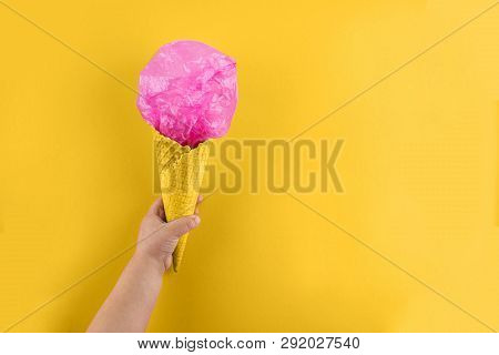Childs Arm Holding Waffle Cone With Polyethylene Package In It. Ecology And Saving Earth Concept. Ou