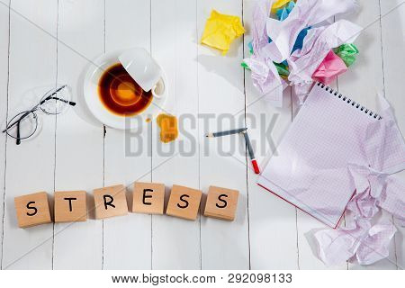 Stationery And Word Stress Made Of Letters On Wooden Background. Education, College, School, Stress,
