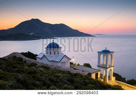 Church On Fourni Island Just Out Of The Main Town And View Of Thymaina Island At Dusk, Greece.