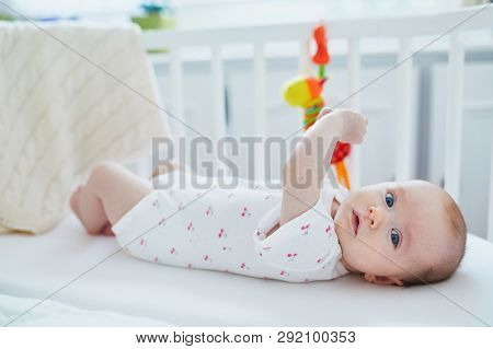 Baby Girl Lying In Co-sleeper Attached To Parents' Bed