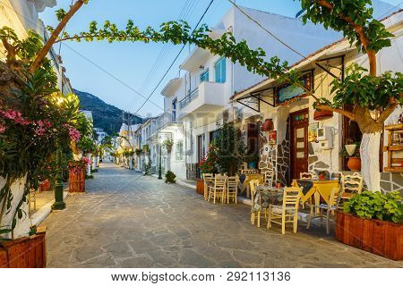 Fourni, Greece - April 29, 2018: View Of The Main Street With Shops And A Restaurant In Fourni, Gree