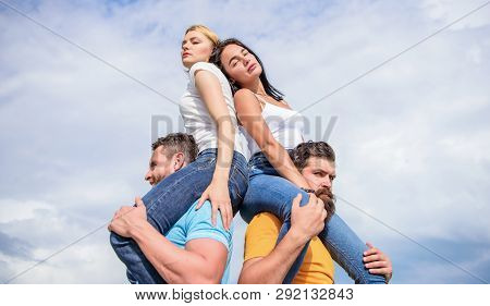 Couples In Love Having Fun. Men Carry Girlfriends On Shoulders. Summer Vacation And Fun. Couples On 