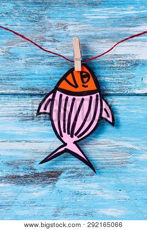 a homemade paper fish, made by myself, as a popular prank for april fools day in countries such as Italy, France, Belgium, Netherlands, Switzerland or Canada hanging from a rope with a clothespin