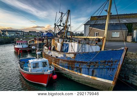 This Is A Picture Of Old An New Boats Moored Up In A Harbour In Ireland