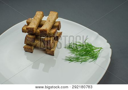 Toasts Are Fried On A Frying Pan With Spices. Served On A White Plate With Garlic Sauce And Barbecue