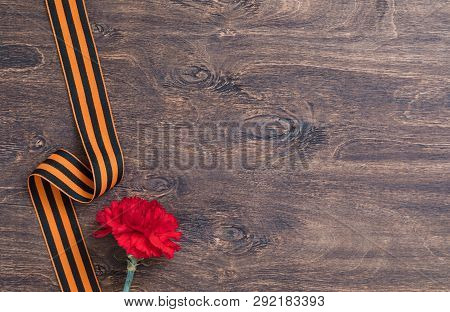 St. George Ribbon And Red Carnation, May 9 Victory Day Concept, Symbol Of The Second World War, Dark