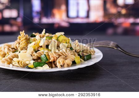 Recipe Step By Step Fusilli Pasta With Zucchini On White Porcelain Plate With A Fork With Restaurant