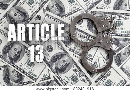 Police Handcuffs And Dollar Bills With Article 13 Inscription