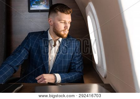 Attractive And Successful Businessman In An Expensive Suit Working Sitting In The Chair Of His Priva