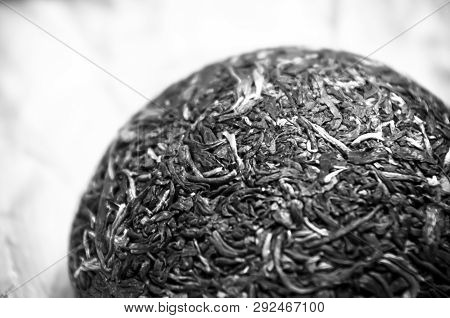 Chinese Pressed Puer Tea On Wrapping Paper, Close-up, Macro