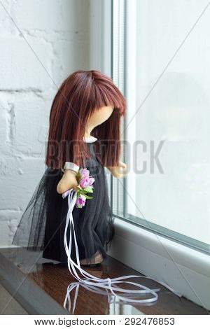 Tilda Doll With Black Hair And A Bouquet Of Purple Flowers. Holidays Decoration. Interior Fairy Doll