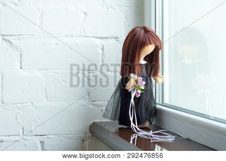 Tilda Doll With Black Hair And A Bouquet Of Purple Flowers. Holidays Decoration. Interior Fairy Doll