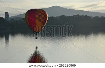 Canberra, Australia - March 10, 2019. Hot Air Balloon Flying In The Air Above Lake Burley Griffin, A