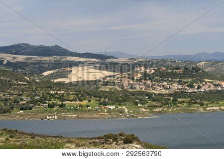Panoramic View Of Kouris Water Reservoir In Cyprus And The Mountains Around On A Cloudy Spring Day