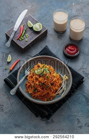 Spicy Asian Mee Goreng Mamak With Eggs, Ketchup And Chili, Top View