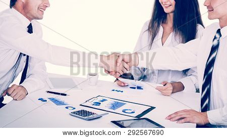 A Group Of Successful Businessmen. Discussion Of Charts And Grap