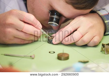 Close Up Of Unrecognizable Factory Worker Assembling Intricate  Mechanical Watch, Copy Space