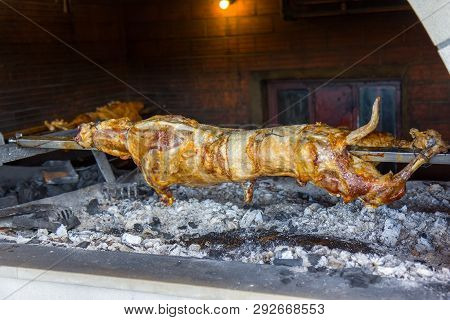 Lamb Being Roasted Whole On A Spit