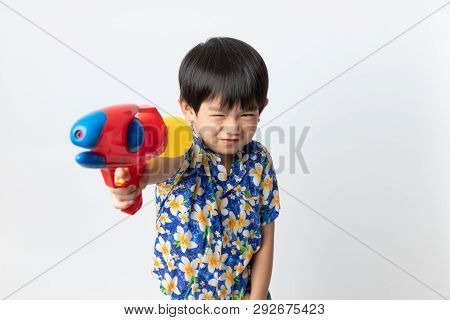 Welcome Thailand Songkran Festival, Portrait Of Asian Boy Wearing Flower Shirt Smiled With Water Gun
