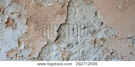 Old Grungy Weathered Wall Background Texture. Beige Dirty Peeled Plaster Wall With Falling Off Flake