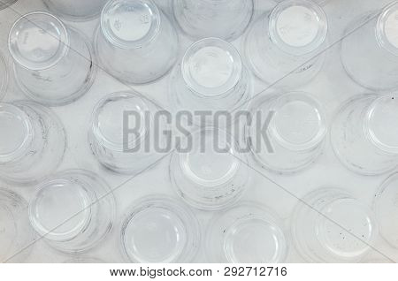 A Lot Of Plastic Cups, Top View, White Background. Increasing The Amount Of Plastic Concept. Non-com