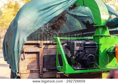 Heavy Industrial Vaccuum Loader Loading Fallen Leaves And Junk Into Truck Body. Municipal Services C