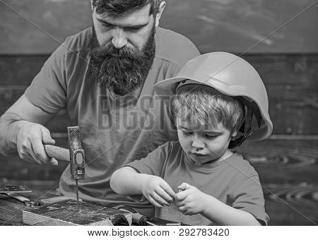 Father, Parent With Beard Teaching Little Son To Use Hobnails And Hammer. Boy, Child Busy In Protect