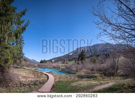 Lake Zelenci, Source Of The Sava Dolinka River, With The Observation Trail Footbridge In Nature Rese