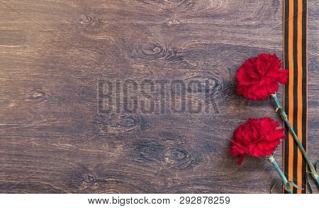 St. George Ribbon And Red Carnation, May 9 Victory Day Concept, Symbol Of The Second World War, Dark