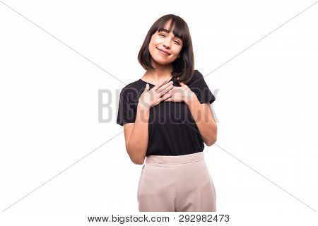 Young Woman Showing Her Heartfelt Gratitude And Thanks Clasping Her Hands To Her Heart With A Please