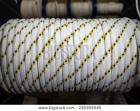 White Rope On A Show-window Of Shop. A Safety Rope For Climbers. The Rope Is Reeled Up On The Coil. 