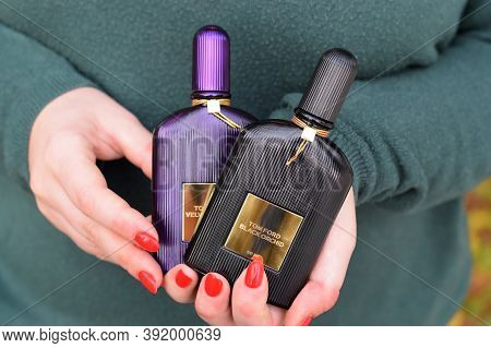 Girl Holds Tom Ford Velvet Orchid And Black Orchid Fragrance Perfume Bottles. Tom Ford Is American F