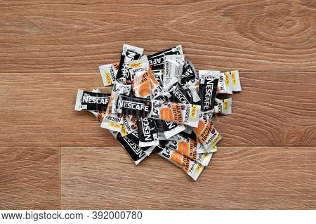 Many Nescafe Caramel Cream Coffee Sticks On Wooden Background. Nescafe Is A Brand Of Coffee Made By 