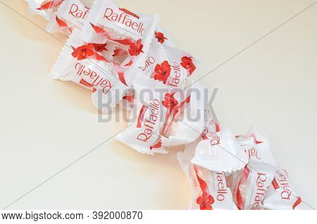 Raffaello Candies On Beige Background. Raffaello Is A Spherical Coconut Almond Confection That Itali