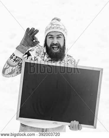 Ok Geture. Happy Hipster With Blackboard. Bearded Man In Warm Clothes. Happy New Year. Winter Season