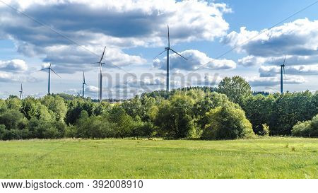 Windmill Park In Reinsfeld Hochwald Sourround Blue Clouds In Summertime In Germany
