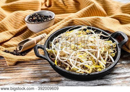 Bowl With Mungbean Sprouts On Wooden Background. White Background. Top View