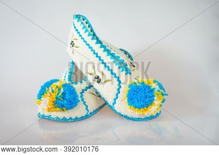 Pair Of Greek Slippers With Pumpons On Gray Background