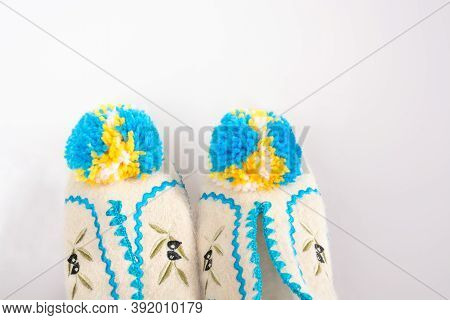 Part Of Greek Slippers With Pumpons On Gray Background