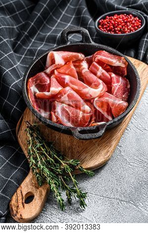 Italian Rolled Bacon Pancetta Piacentina. Pork Meat. White Background. Top View