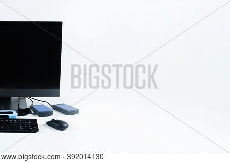 Multiple External Hard Drives Connected To A Monoblock On A White Background.computer With Hard Driv