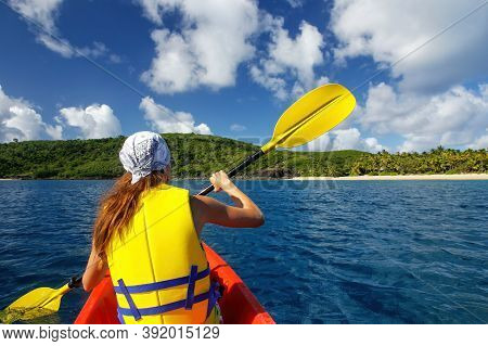 Young Woman Kayaking Near Drawaqa Island In Yasawas, Fiji. The Yasawa Group Consists Of 6 Main Islan