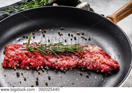 Raw Strip Vegas Steak In A Pan With Cooking Ingredients. Gray Background. Top View