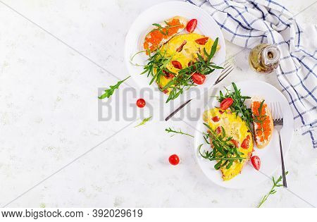 Omelette With Tomatoes, Cheese, Ham And Sandwich Wich Red Cavier On Plate.  Frittata - Italian Omele