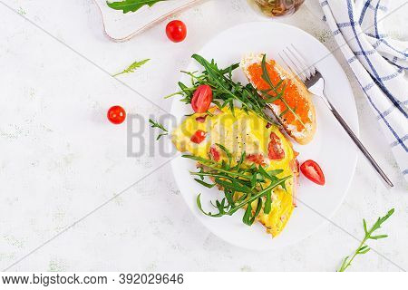 Omelette With Tomatoes, Cheese, Ham And Sandwich Wich Red Cavier On Plate.  Frittata - Italian Omele